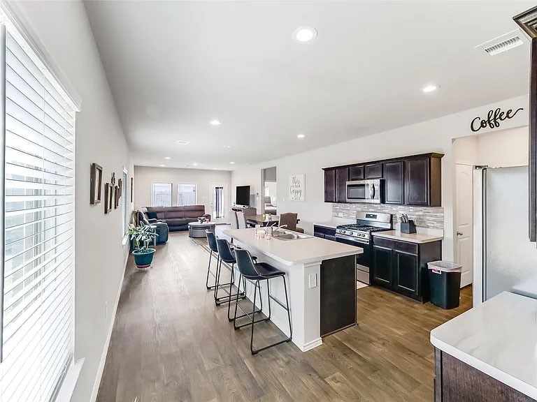2406 High Spruce Circle Spring, TX 77373 - Photo 5 of 32 a kitchen with lots of counter top space and stainless steel appliances
