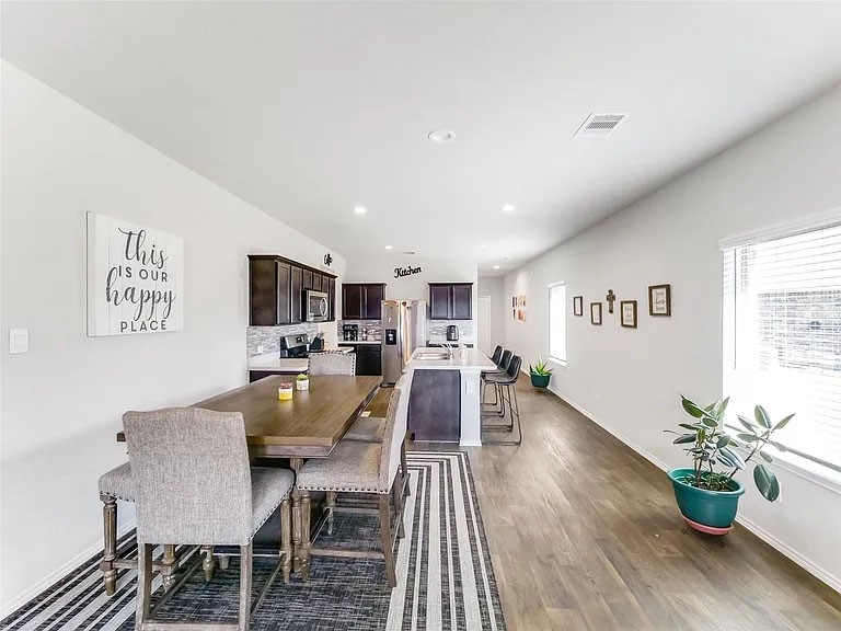 2406 High Spruce Circle Spring, TX 77373 - Photo 7 of 32 a view of a dining room with furniture and wooden floor