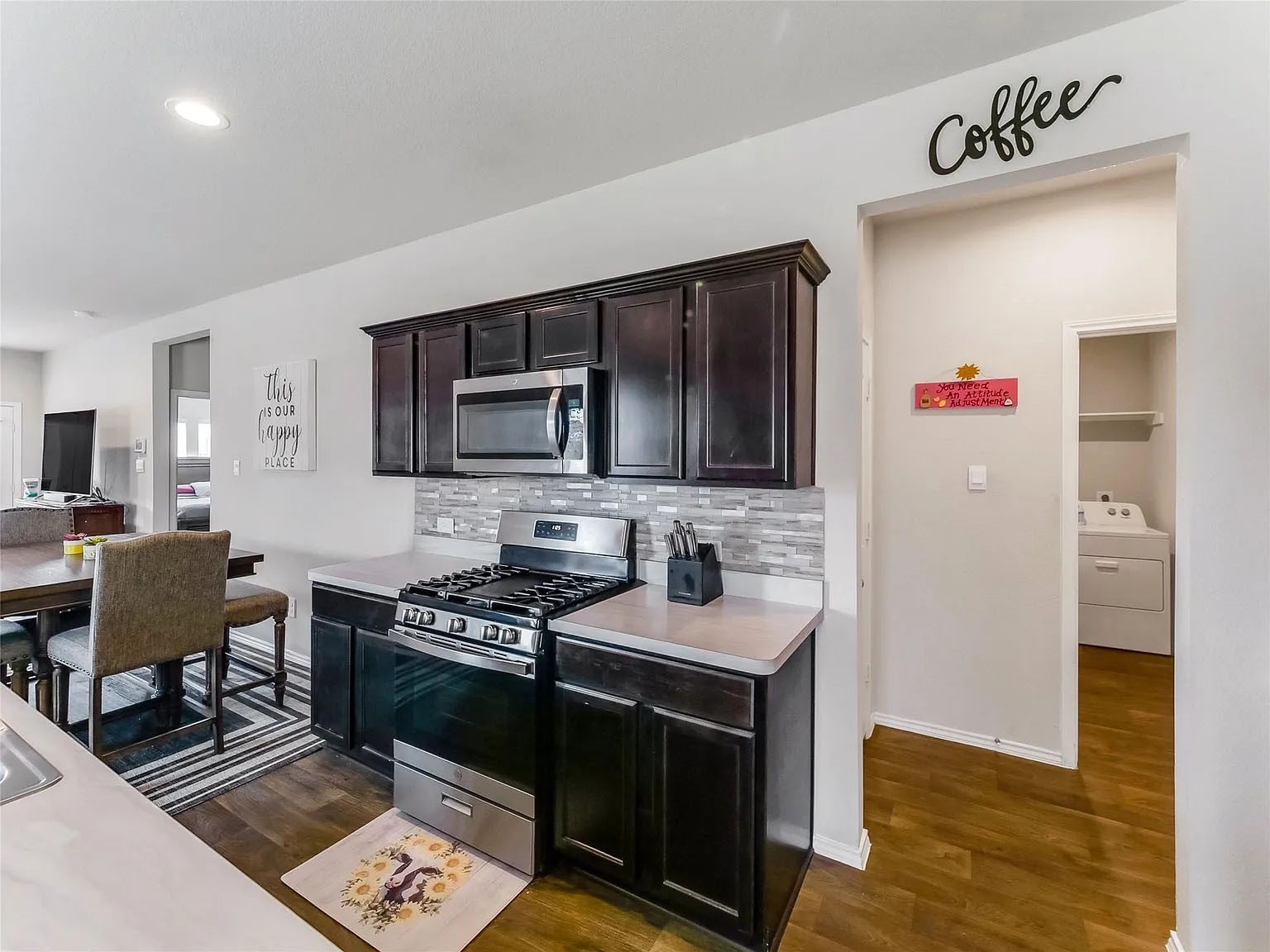 2406 High Spruce Circle Spring, TX 77373 - Photo 9 of 32 a kitchen with stainless steel appliances a stove microwave and a refrigerator