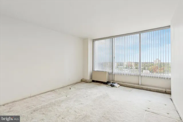an empty room with floor to ceiling window