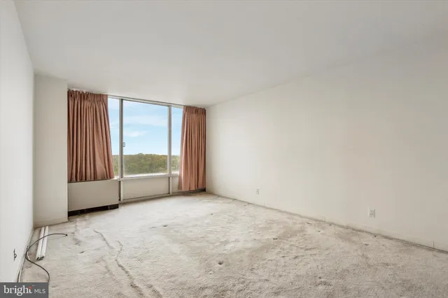 an empty room with large windows