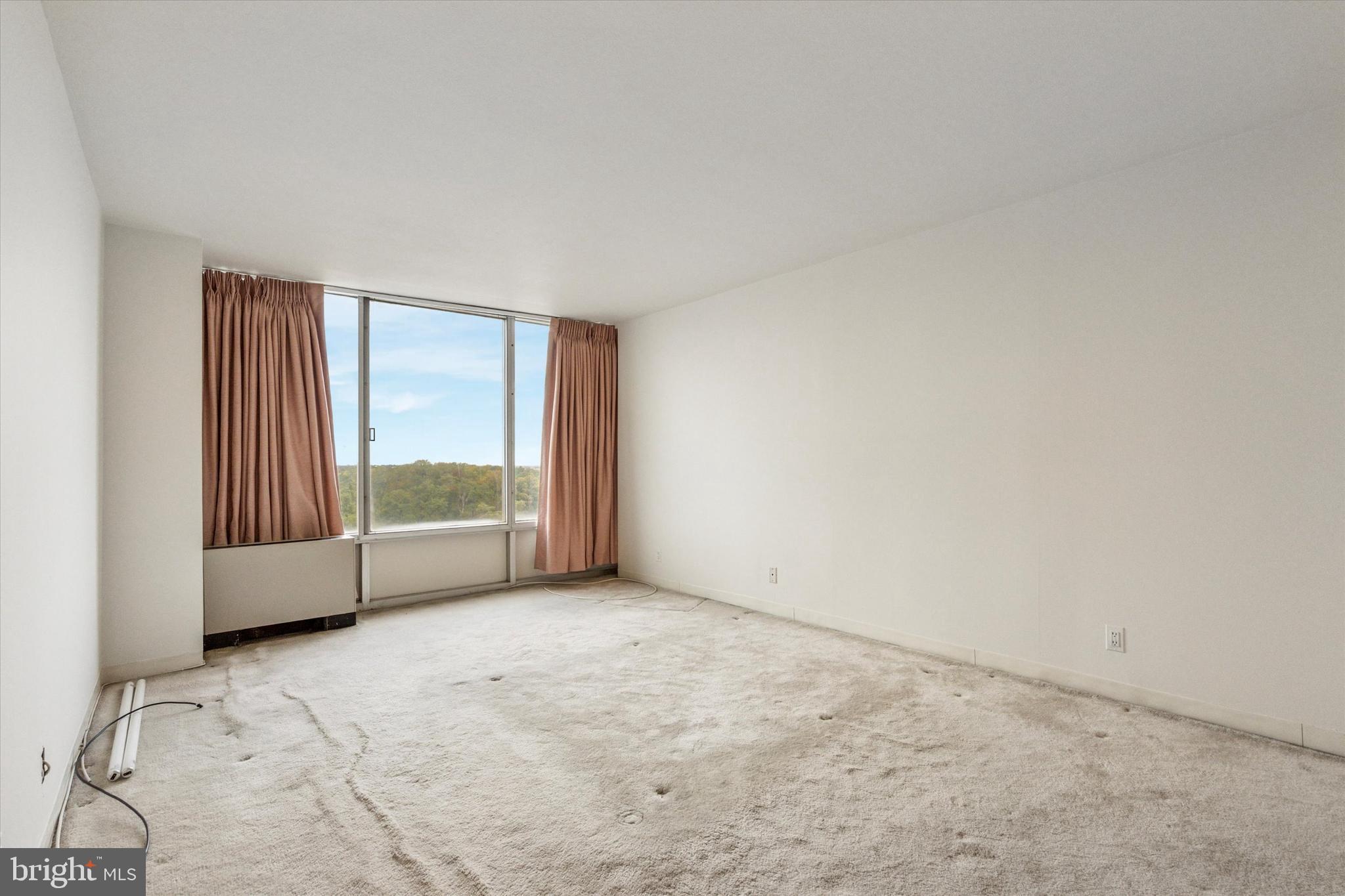 3900 West Ford Road, Unit 15C Philadelphia, PA 19131 - Photo 13 of 15 an empty room with large windows