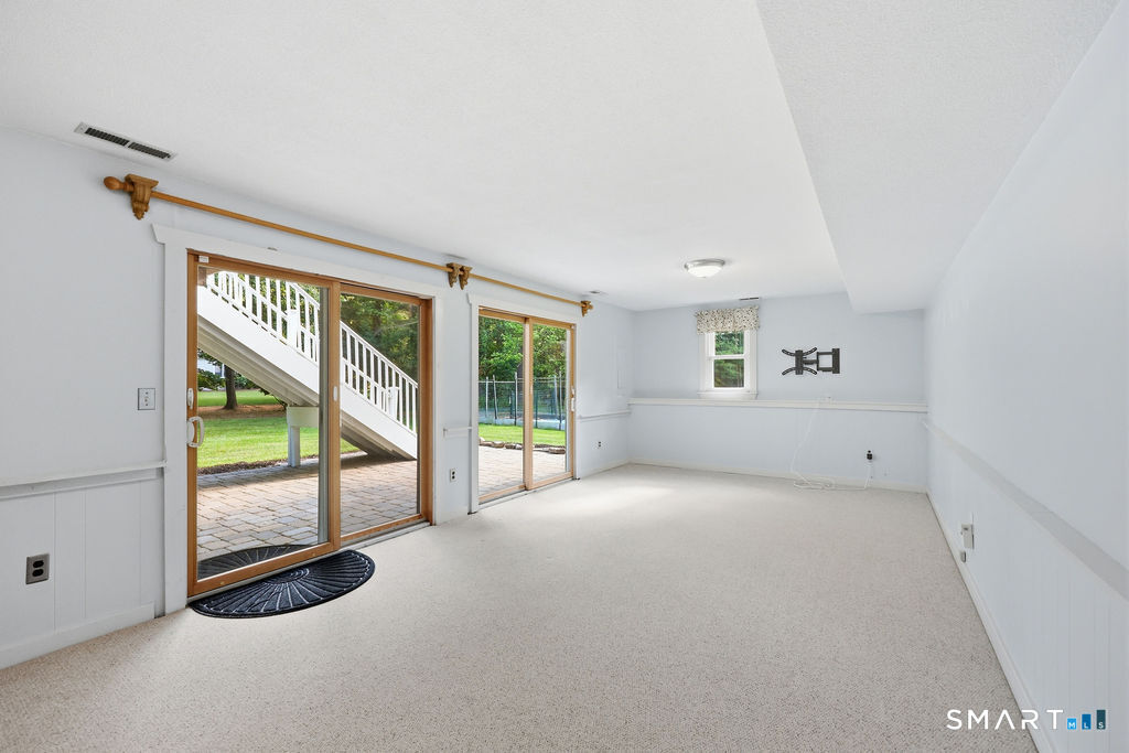 36 Banks Road Simsbury, CT 06092 - Photo 30 of 37 Walkout finished basement recreation room, has access to the backyard patio.