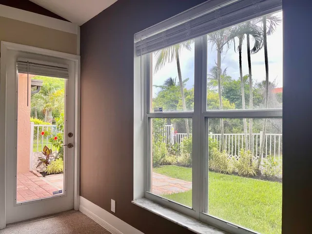 a front view of a house with a yard and trees