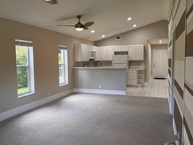 a kitchen with a sink a stove and cabinets