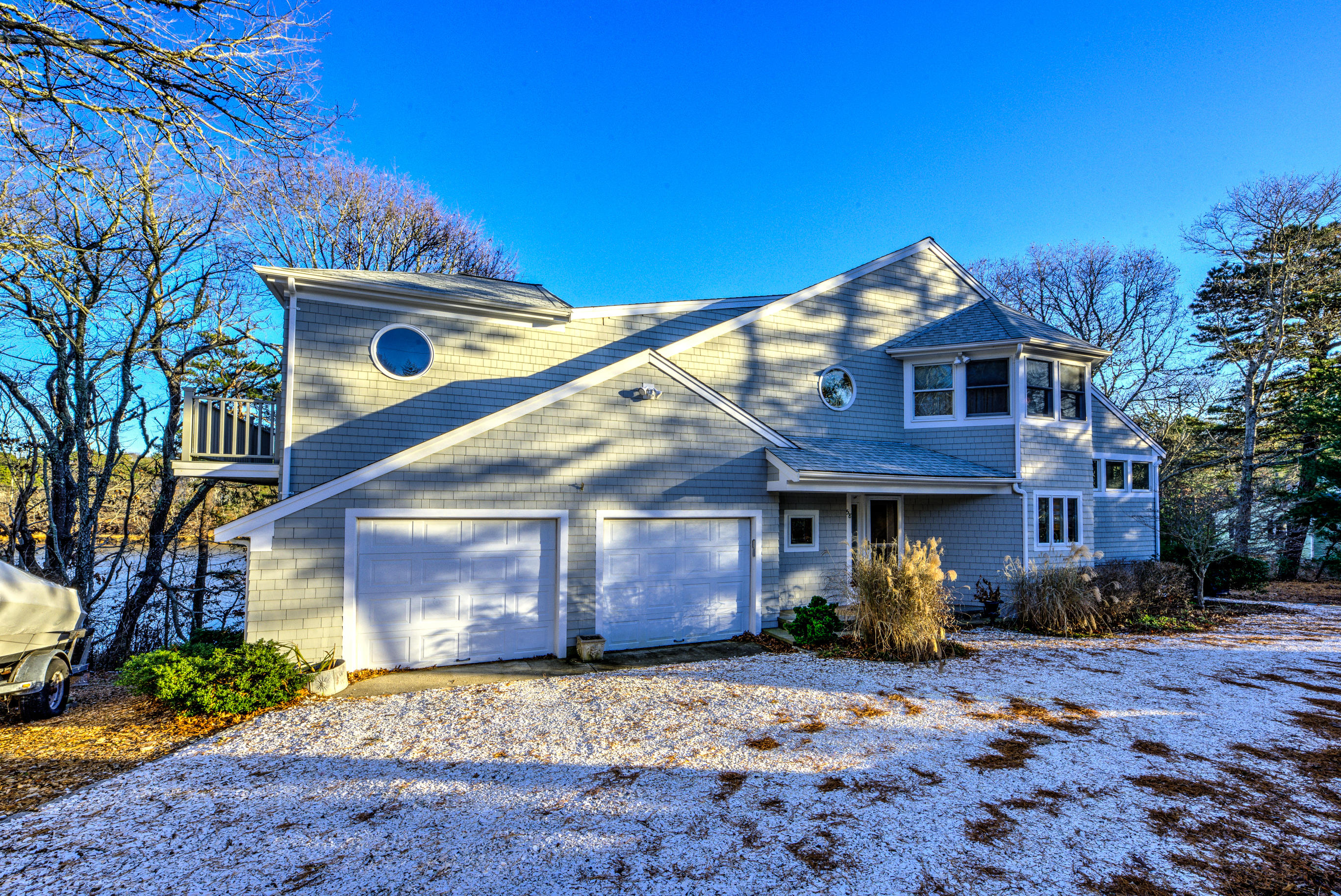 58 Quaker Run Road Mashpee, MA 02649 - Photo 3 of 34 a front view of a house with a yard