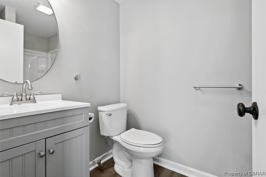 8636 Diascund Road Lanexa, VA 23089 - Photo 32 of 50 Bathroom featuring hardwood floors, mirror, and vanity
