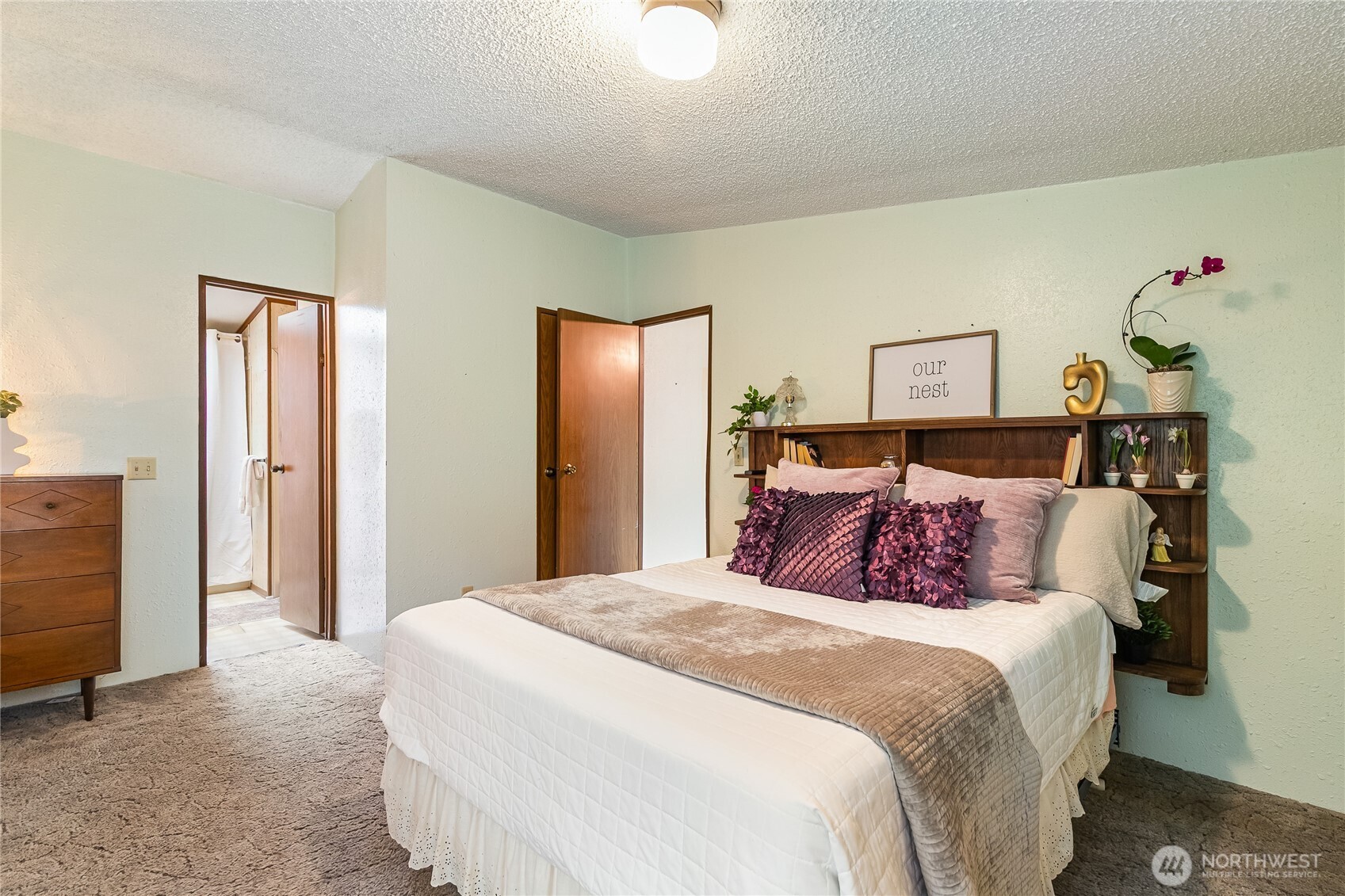 3191 Creasey Road Custer, WA 98240 - Photo 18 of 36 a bedroom with a large bed and a chandelier