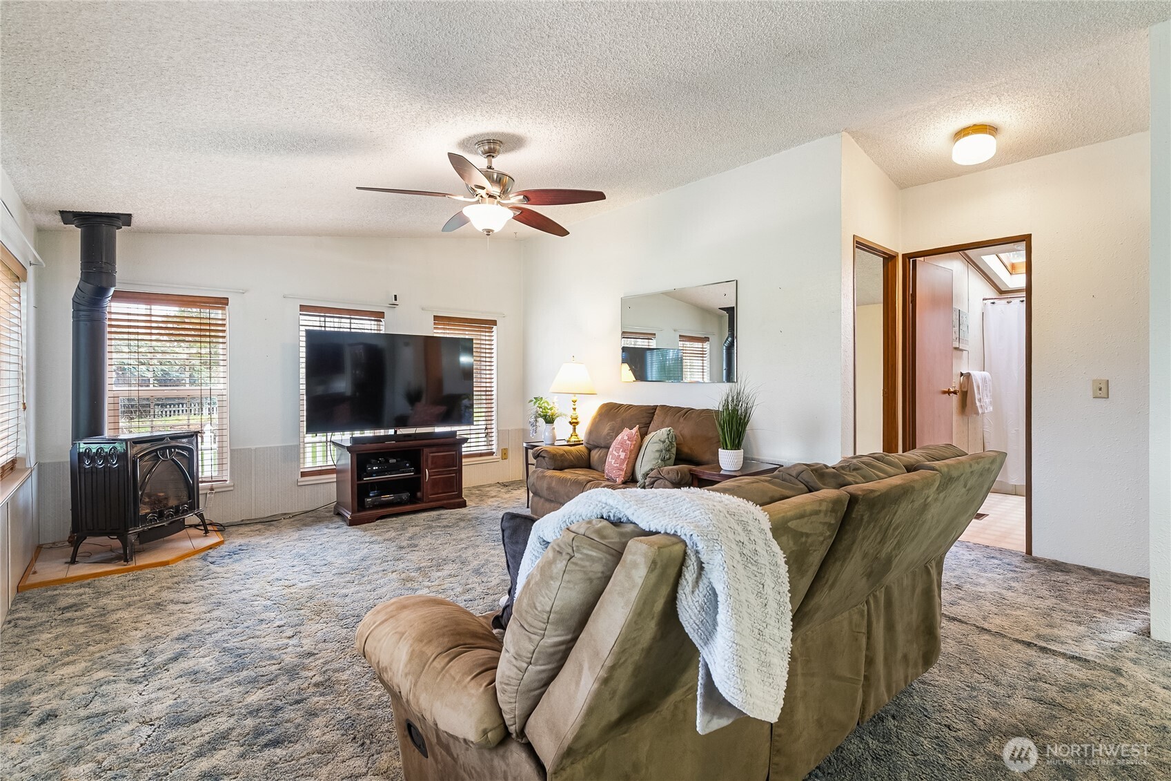 3191 Creasey Road Custer, WA 98240 - Photo 21 of 36 a living room with furniture a flat screen tv and a large window