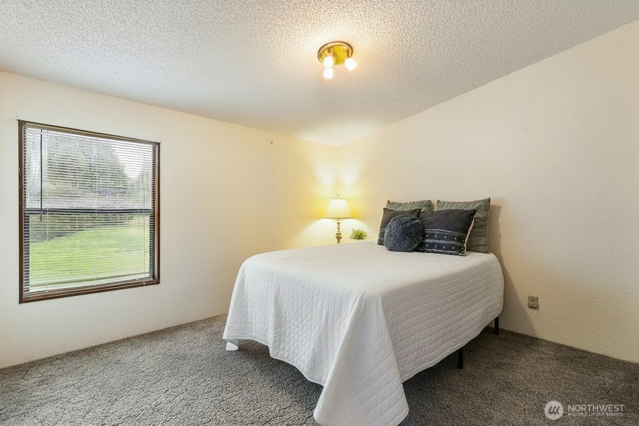 3191 Creasey Road Custer, WA 98240 - Photo 25 of 36 a bedroom with a bed and window