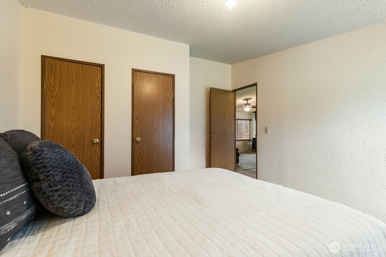 3191 Creasey Road Custer, WA 98240 - Photo 27 of 36 a bedroom with a bed and wooden floor