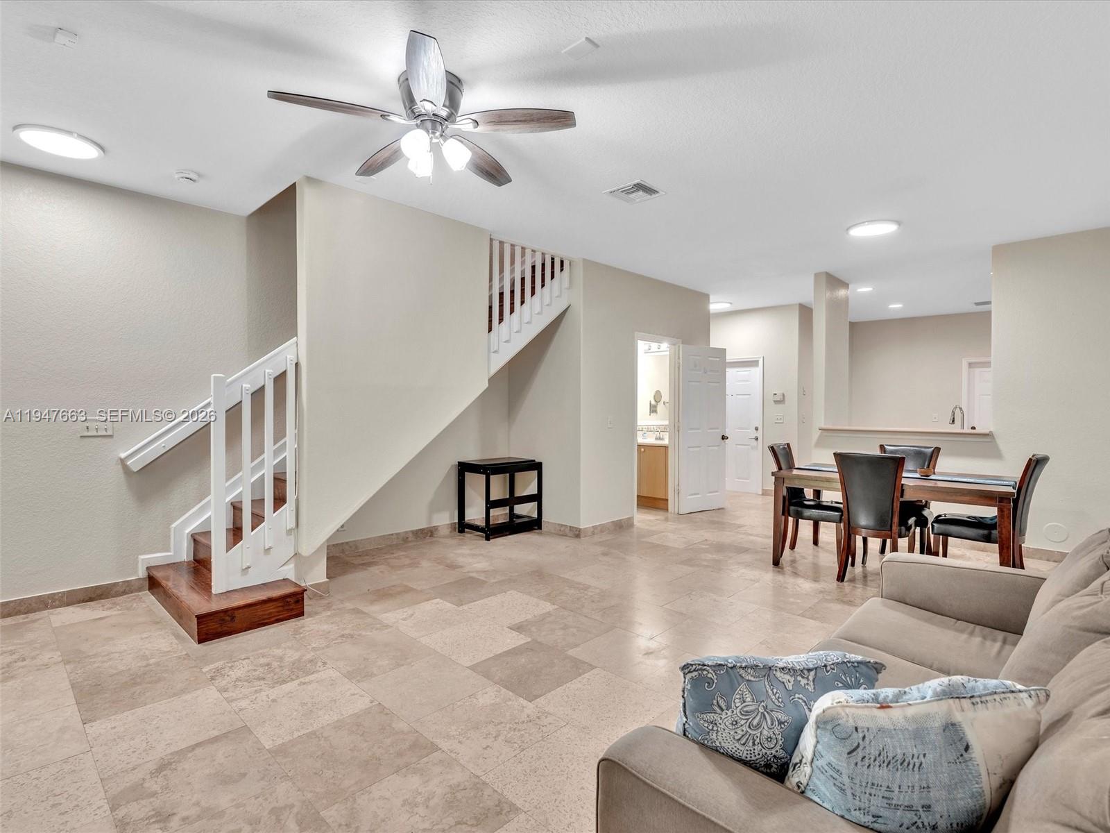 3853 Tree Top Drive, Unit 3853 Weston, FL 33332 - Photo 15 of 43 a living room with furniture and kitchen view
