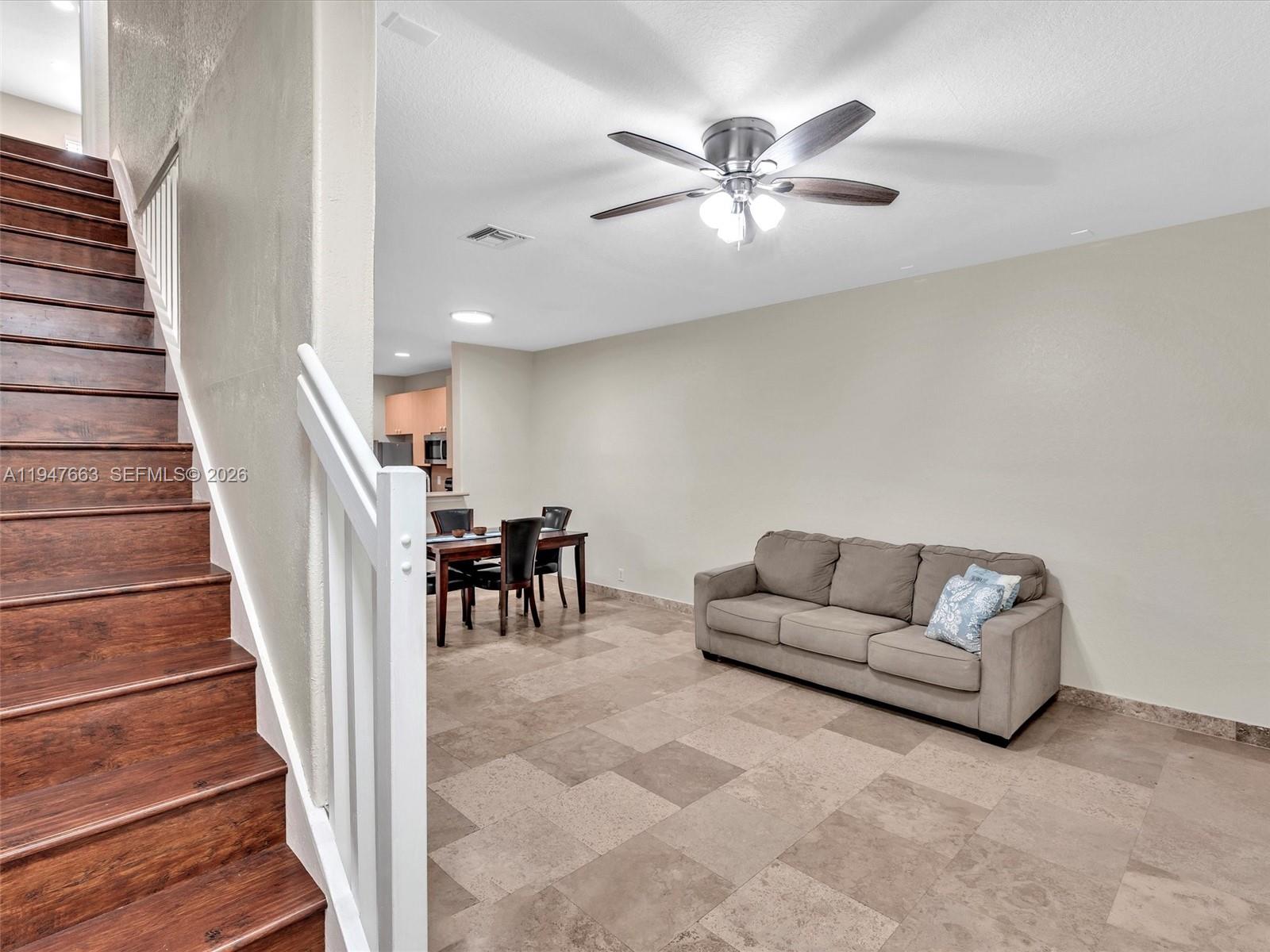 3853 Tree Top Drive, Unit 3853 Weston, FL 33332 - Photo 21 of 43 a living room with furniture and stairs