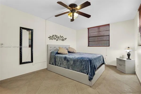 a bedroom with a large bed and a flat screen tv