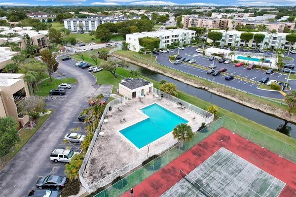 an aerial view of residential houses with outdoor space and river