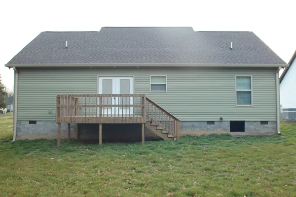 a view of a house with a yard and a large window
