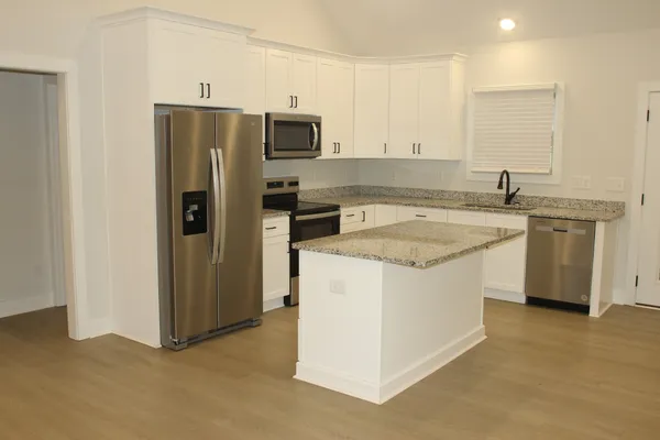 a kitchen with a sink stove and refrigerator