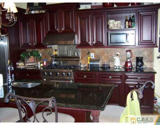 115 Westley Road Old Bridge, NJ 08857 - Photo 2 of 10 a kitchen with a sink and cabinets