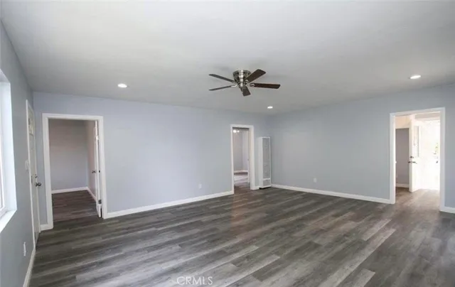 a view of room with hardwood floor and ceiling fan