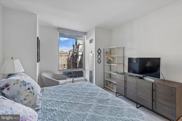 a bedroom with two beds and a flat screen tv