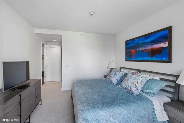 a bedroom with a bed and flat screen tv