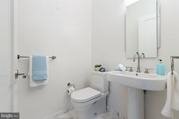 a bathroom with a sink mirror and toilet