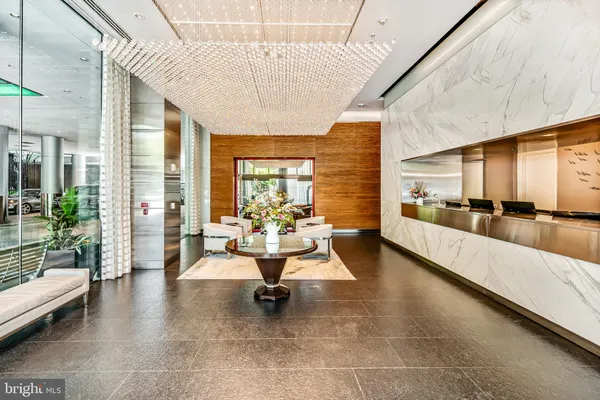 a lobby with furniture and floor to ceiling window