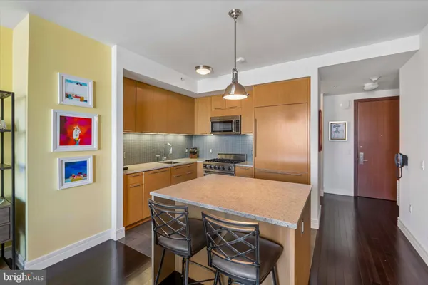 a kitchen with stainless steel appliances granite countertop a refrigerator a sink and a stove