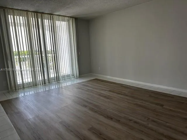 wooden floor in a room next to a window