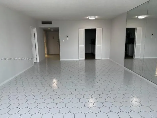 an empty room with fan and natural light