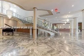 a view of a hallway with a table and chairs