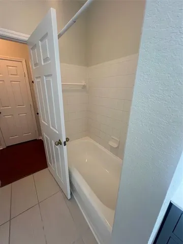 a bathroom with a white bath tub and a shower