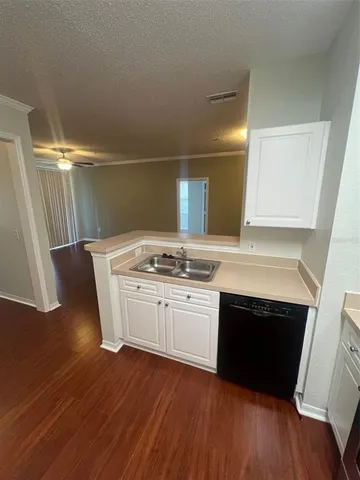 a kitchen with a sink and cabinets