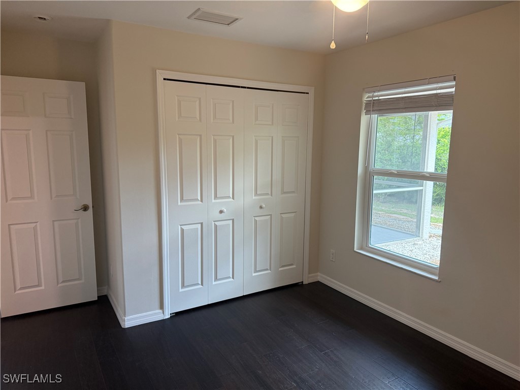 18249 Oak Road Fort Myers, FL 33967 - Photo 11 of 16 a view of an empty room with wooden floor and a window