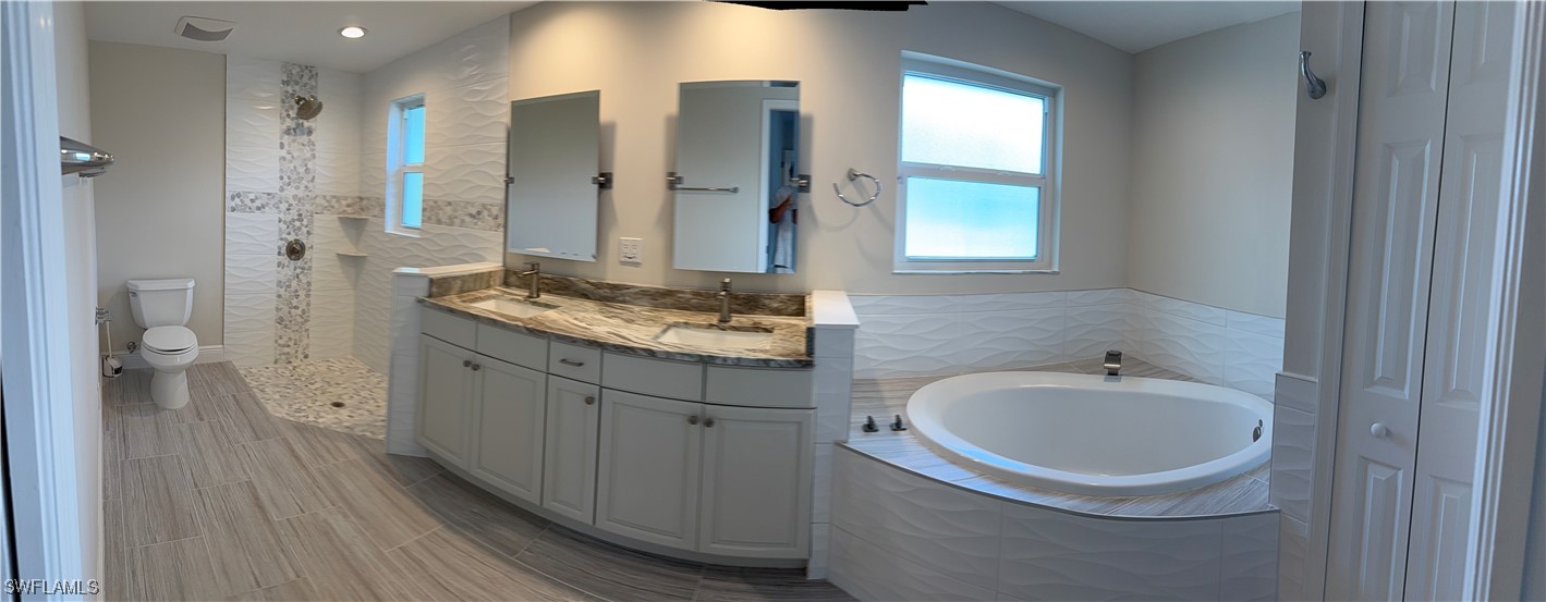 18249 Oak Road Fort Myers, FL 33967 - Photo 14 of 16 a bathroom with a sink a toilet and shower