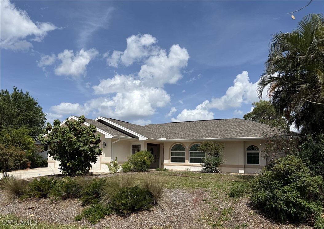 18249 Oak Road Fort Myers, FL 33967 - Photo 2 of 16 a front view of a house with garden