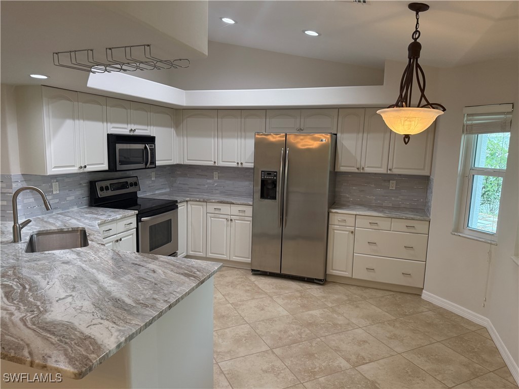 18249 Oak Road Fort Myers, FL 33967 - Photo 6 of 16 a kitchen with refrigerator cabinets and a sink