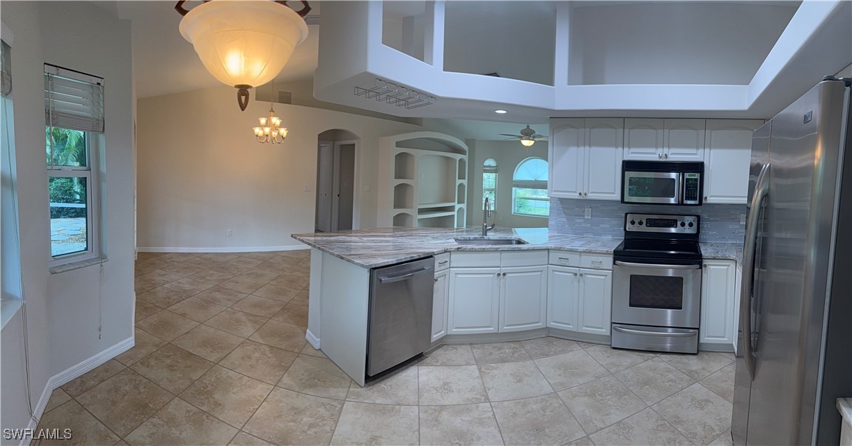 18249 Oak Road Fort Myers, FL 33967 - Photo 7 of 16 a kitchen with a sink and stainless steel appliances