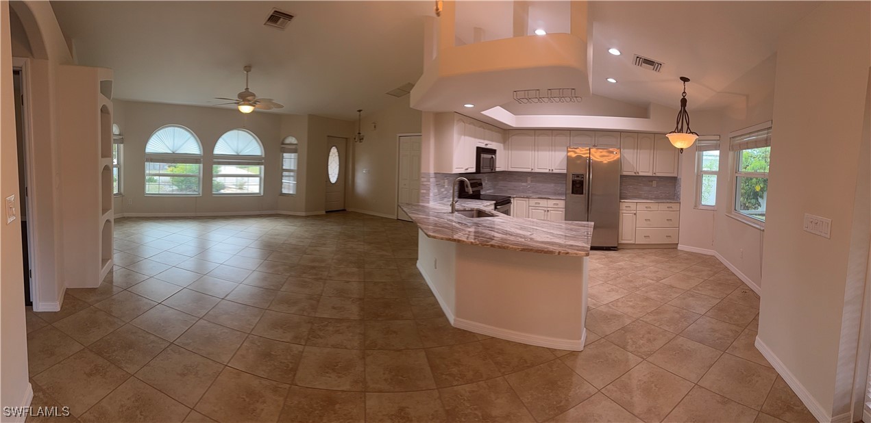 18249 Oak Road Fort Myers, FL 33967 - Photo 8 of 16 a view of a living room and kitchen with a large window