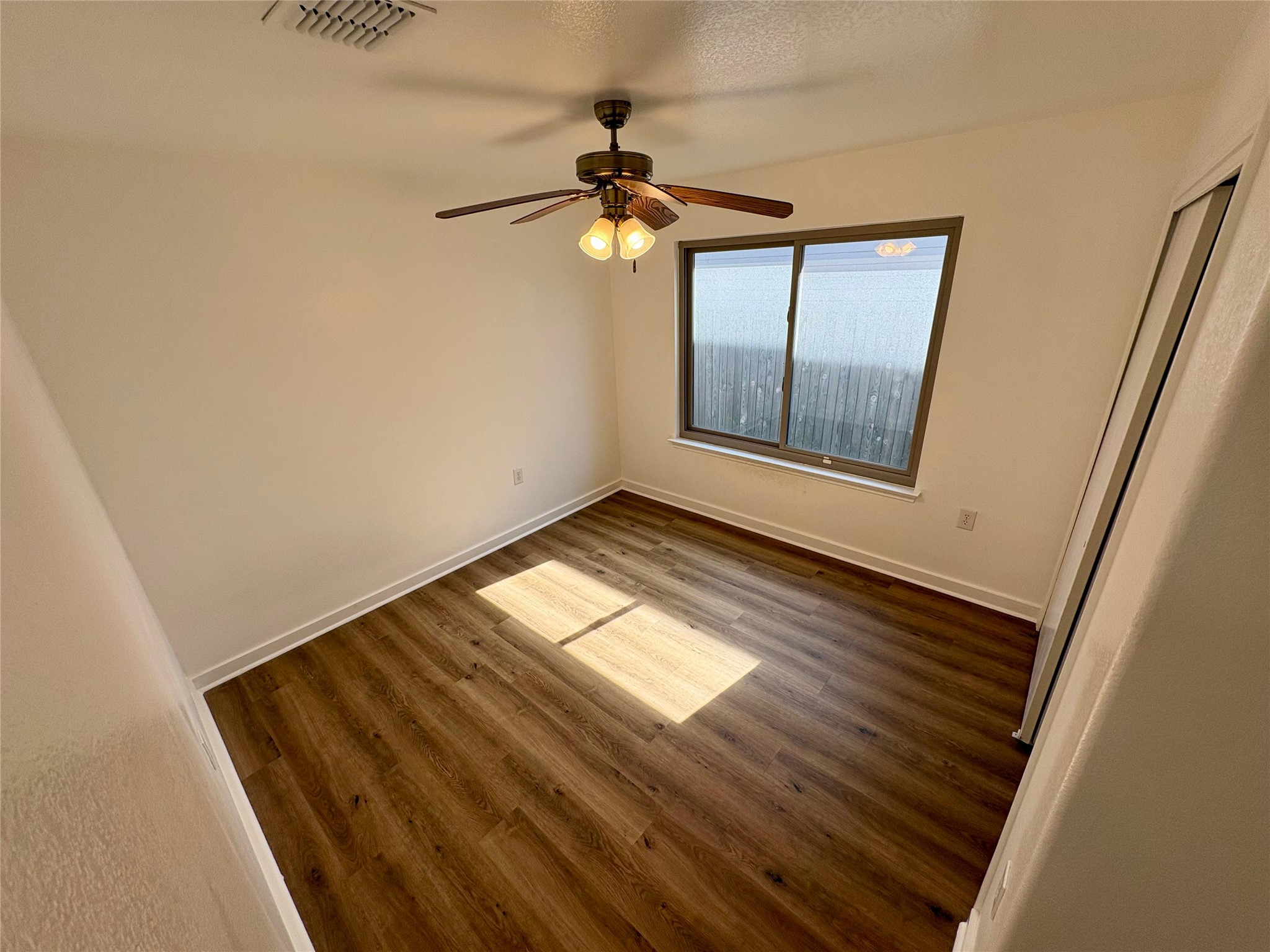 8003 Bannock Lane Austin, TX 78747 - Photo 25 of 40 Bedroom #2 featuring dark wood-type flooring, a closet, and ceiling fan