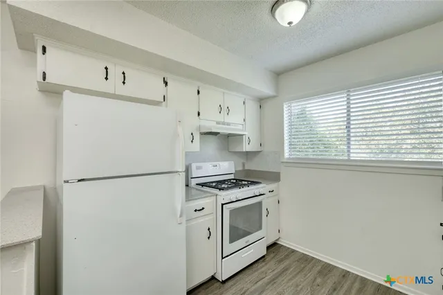 a white refrigerator freezer sitting inside of a kitchen