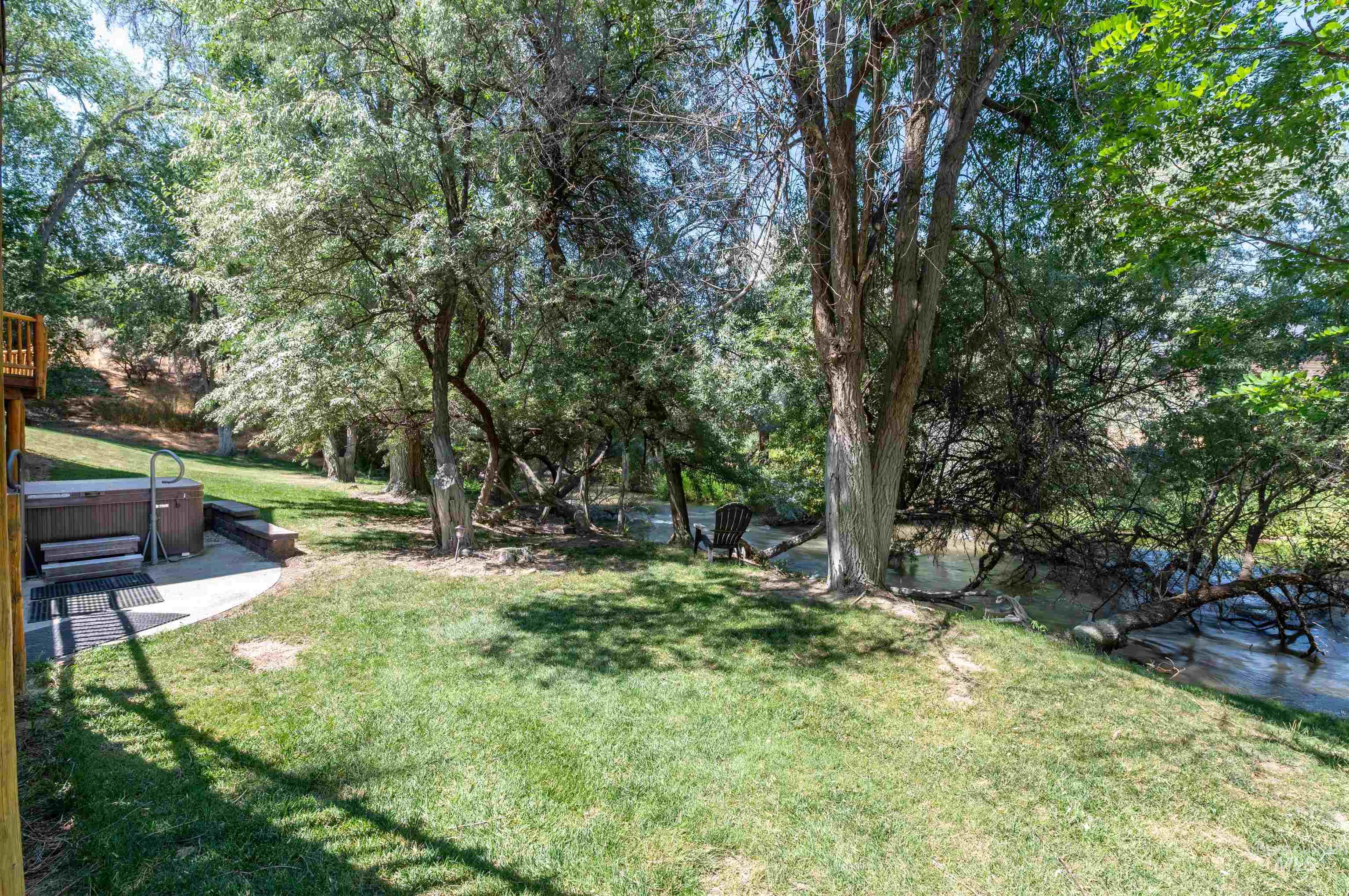 1314 River Road Buhl, ID 83316 - Photo 37 of 45 View of green lawn with a hot tub and view of wooded area