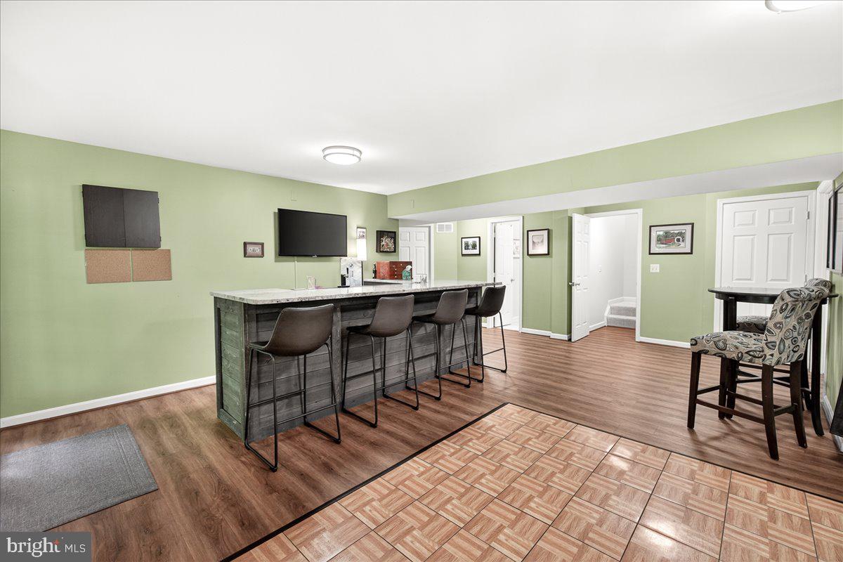 10490 Lakeridge Court New Market, MD 21774 - Photo 37 of 79 a view of a dining room with furniture and wooden floor