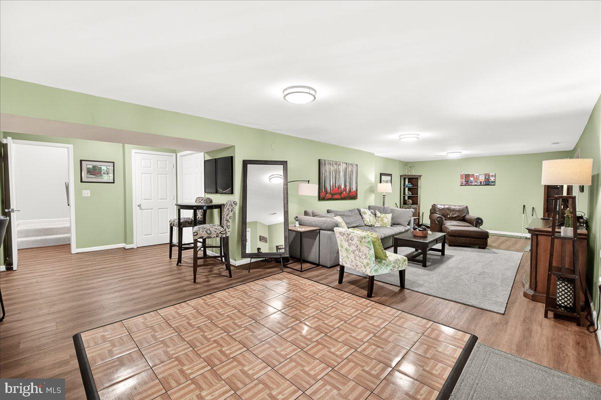 10490 Lakeridge Court New Market, MD 21774 - Photo 38 of 79 a living room with furniture rug and wooden floor