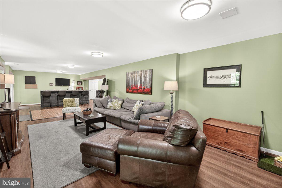 10490 Lakeridge Court New Market, MD 21774 - Photo 39 of 79 a living room with furniture and a flat screen tv