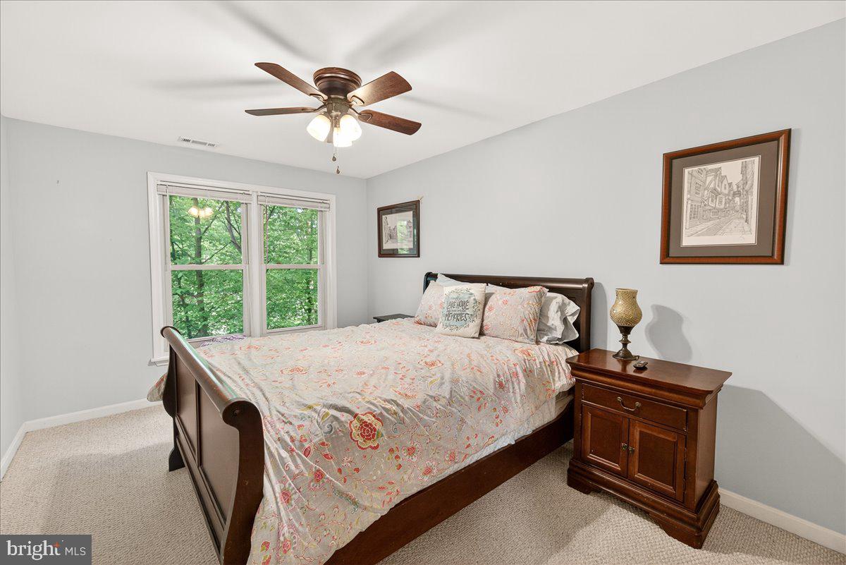 10490 Lakeridge Court New Market, MD 21774 - Photo 42 of 79 a bedroom with a bed and a chandelier