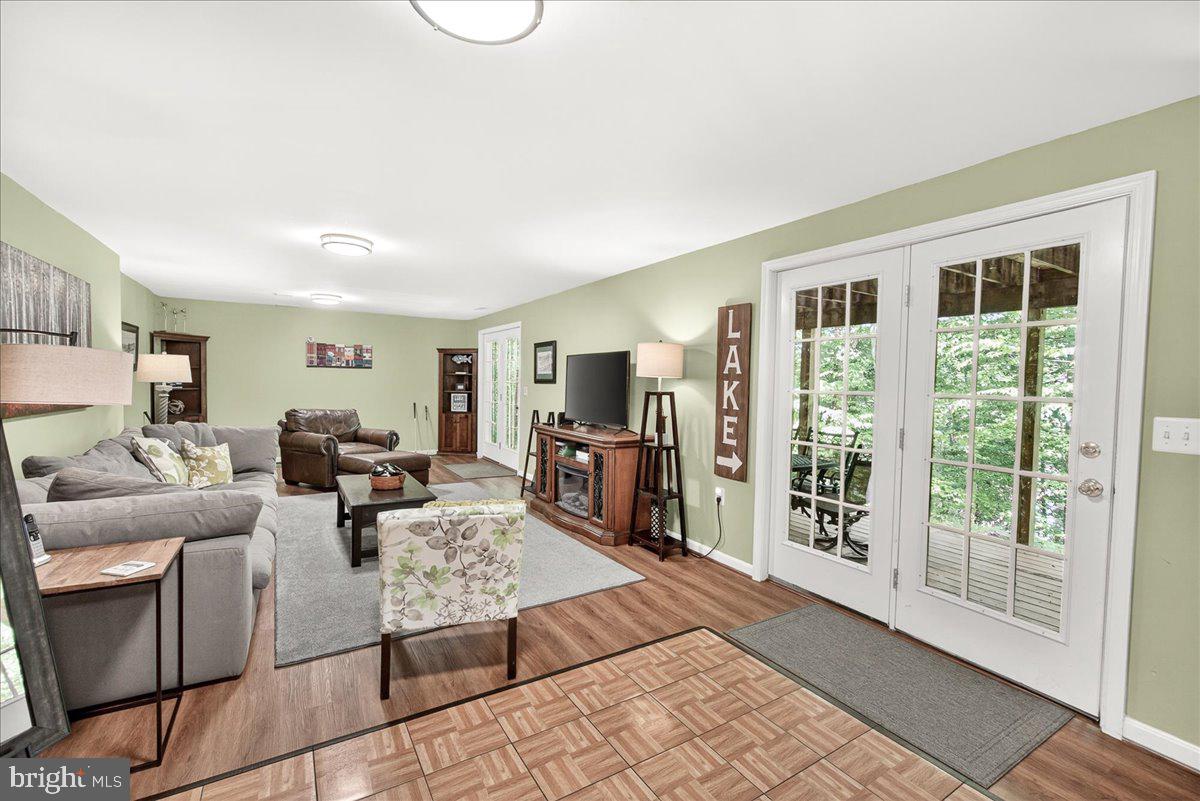 10490 Lakeridge Court New Market, MD 21774 - Photo 43 of 79 a living room with furniture large window and flat screen tv