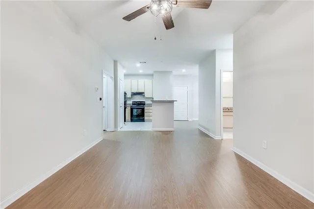 a view of a kitchen with a sink and a refrigerator