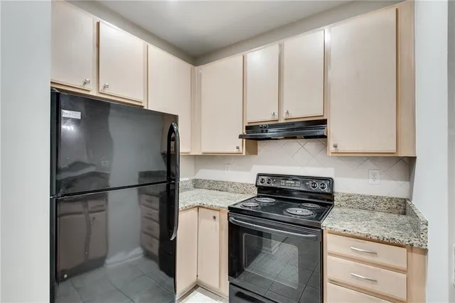 a kitchen with appliances cabinets and a counter top space