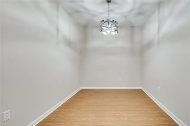a view of empty room with window and ceiling fan
